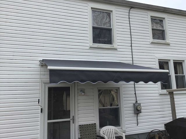 Awning installed over exterior door at back of house