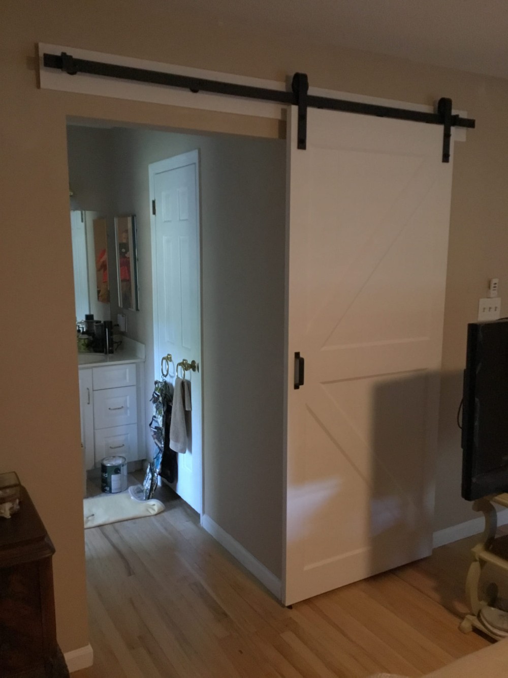 Barn door installation inside house - white door with dark header