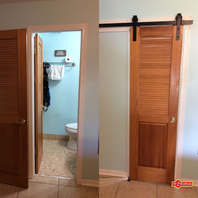 Old bathroom door has been replaced with a stylish barn door.