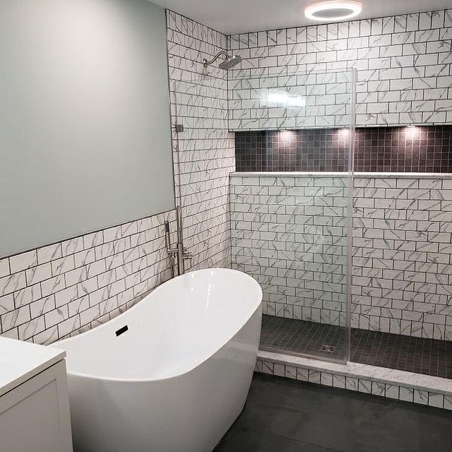 Renovated bathroom with large white tub