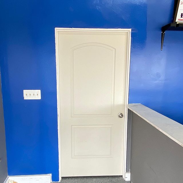 Blue drywall with white door.
