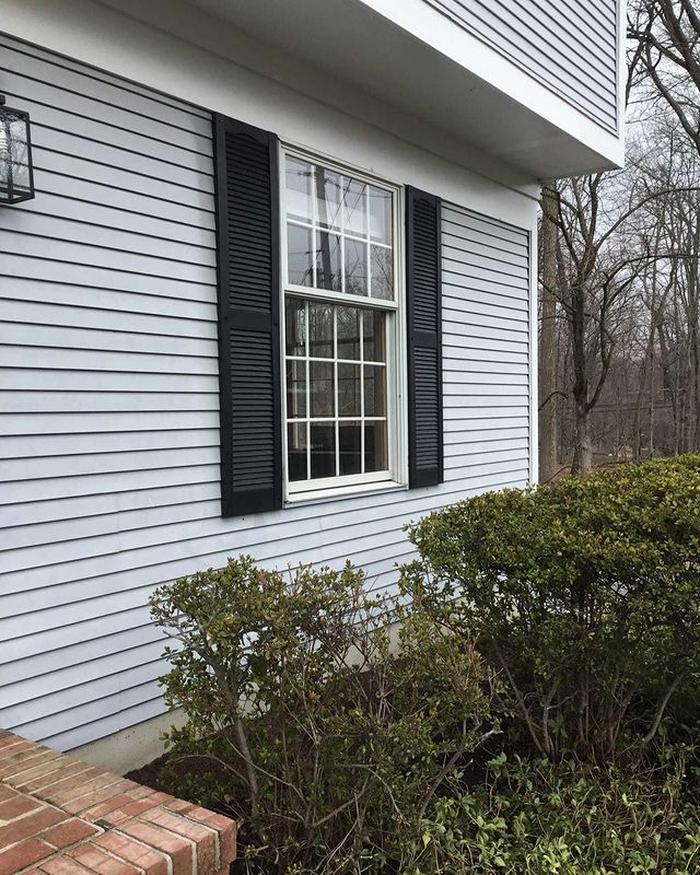 Shutters hanging next to exterior window