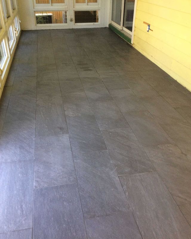 installation of vinyl laminate flooring on back porch.