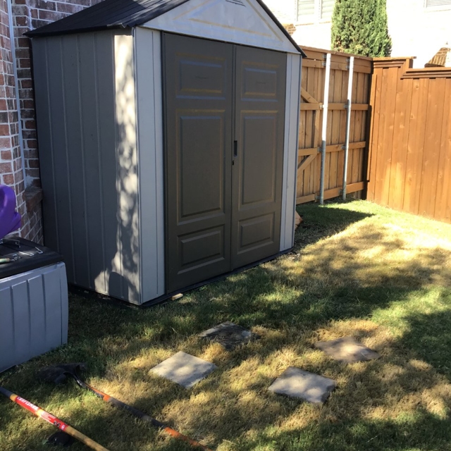 Assembled shed in a back yard.