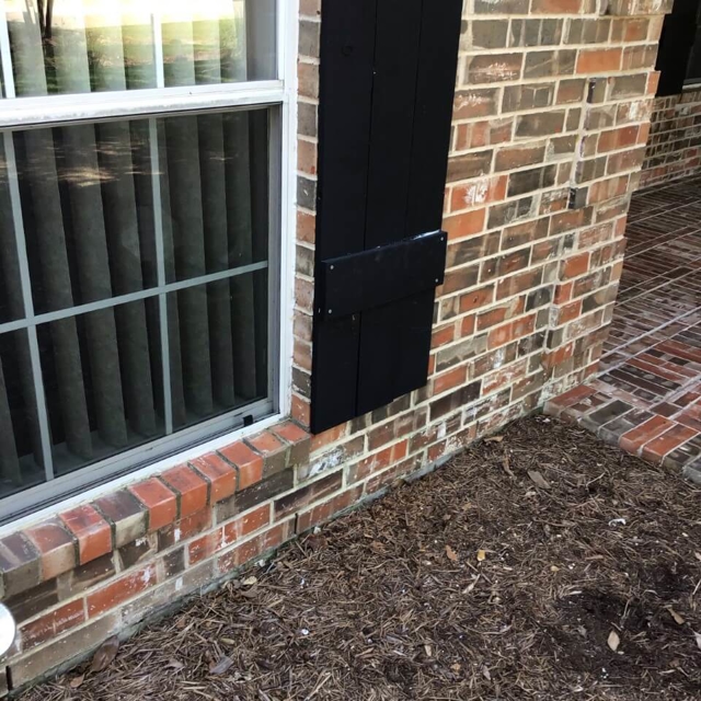 Close up of a shutter replacement done on a brick home.