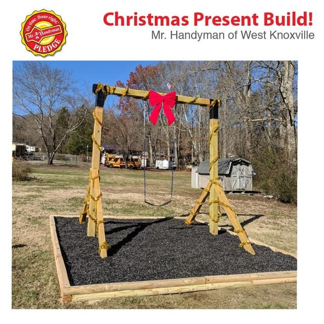 Single person swing set and sand box with a bow on it