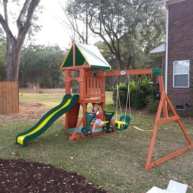 Swing set with child on a swing.