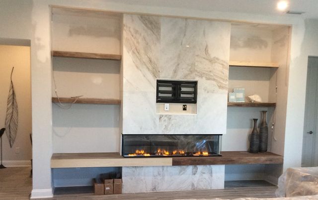 Designed fireplace and functional shelving.