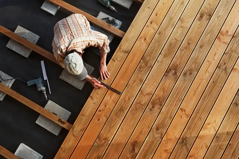 A handyman building a floating deck.