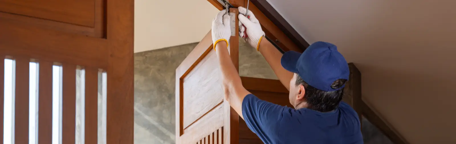 A handyman fixing a sagging door