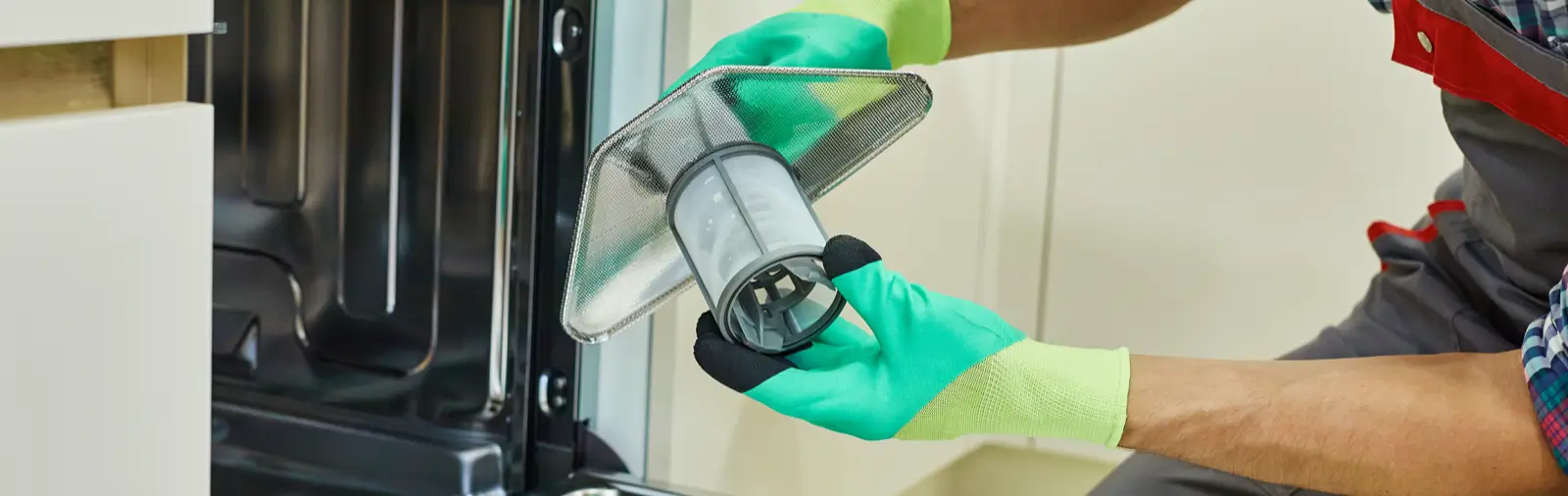 A handyman installing dishwasher parts