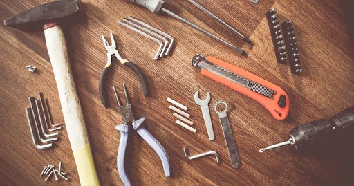 A collection of hand tools and small parts that would be used by a handyman in Summerville, SC.