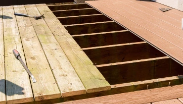 A deck with boards that have been removed and new boards that have been added during an appointment for Charleston deck repair.