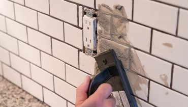 Person working on white backsplash