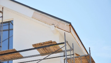 A house being built with scaffolding on the side of it.