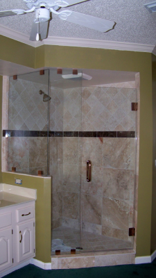 A modern bathroom with a glass-enclosed shower.