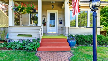 The front porch of a two story home that has been maintained with professional porch repairs.