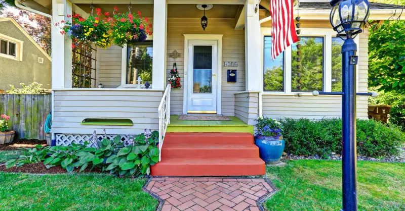 The front porch of a two story home that has been maintained with professional porch repairs.