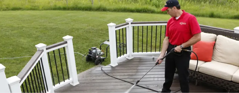 Mr. Handyman technician power washing deck in Naples, FL