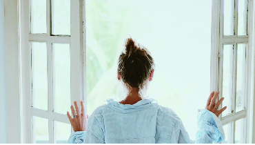 woman opening french doors