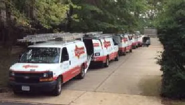  Mr. Handyman vans parking besides the road.