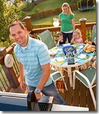 Family barbecuing on their patio.