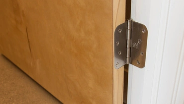 A close-up of a door hinge.