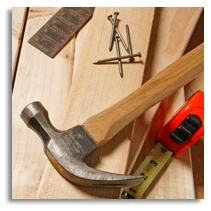 hammer sitting on some wood planks