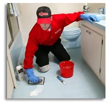 Handyman adding grout to tile