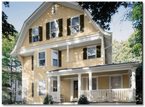 Charming yellow home with white trim nestled in a serene setting.