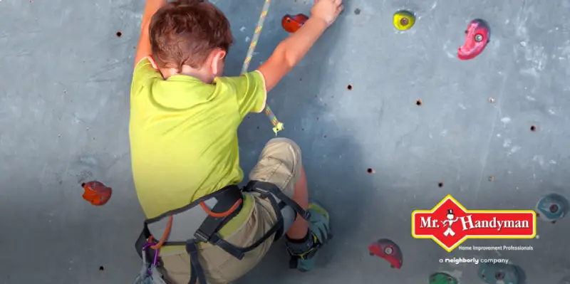 Child climbing a rock wall.