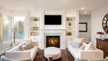 Beautiful living room with lit fireplace.