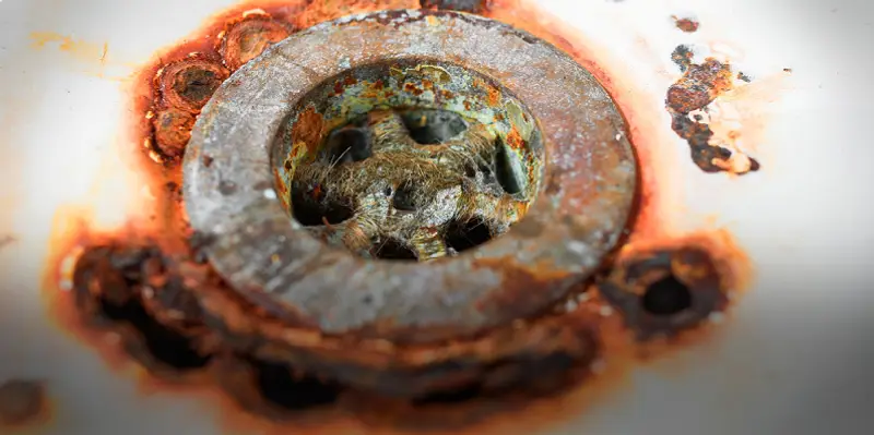 A close up of a rusted drain.