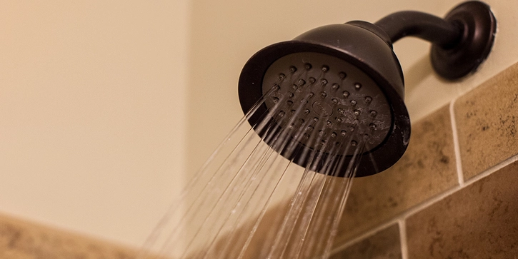 Shower head spraying water.