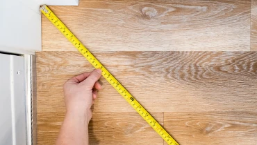 Measuring tape on a wooden board.