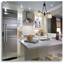 A kitchen with a refrigerator and a sink.