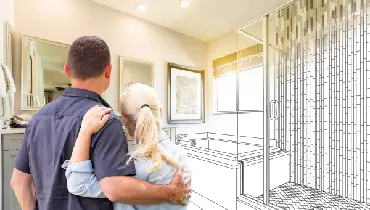 Couple looking at an illustrated rendition of a bathroom remodel.