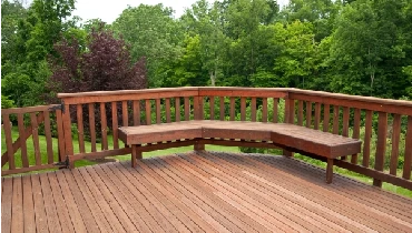 A wooden deck with a bench.