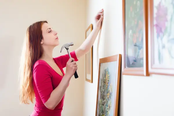 Girl red hanging pictures frames.