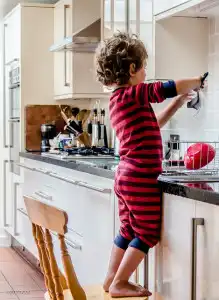 child helping in the kitchen.