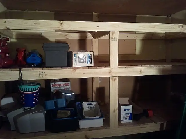 A shelf with boxes and a flashlight.