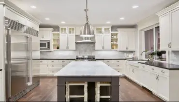 Kitchen with island and white cabinets.