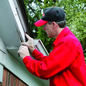 Mr. Handyman technician fixing roof siding