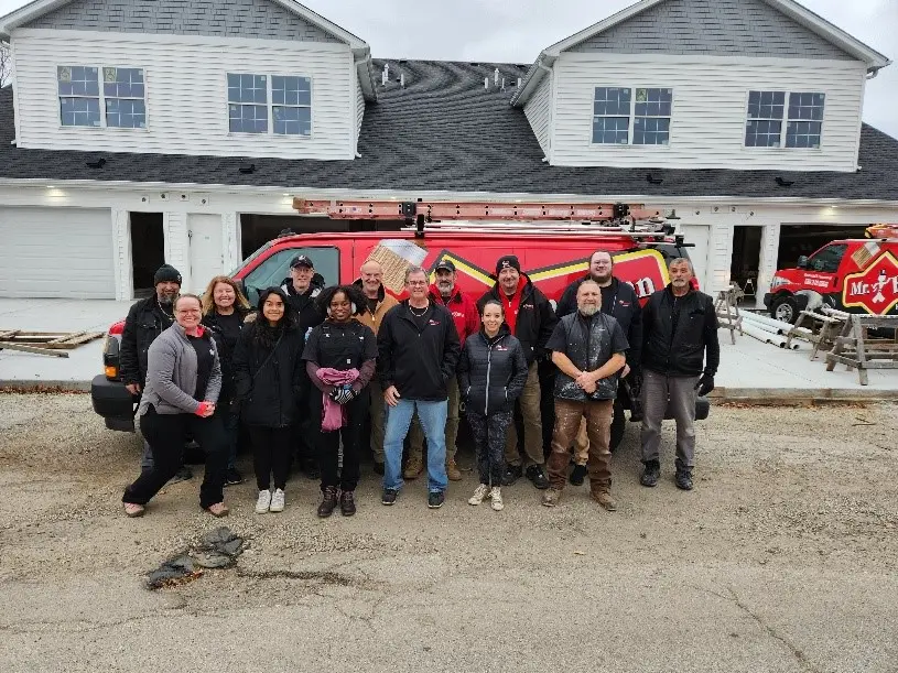 The MRH Wheaton-Hinsdale team outside a home they assisted building for Habitat for Humanity.