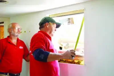 Mr. Handyman technicians measuring a window.