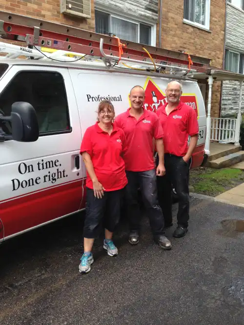 Mr. Handyman of Wheaton-Hinsdale technicians next to branded company van.