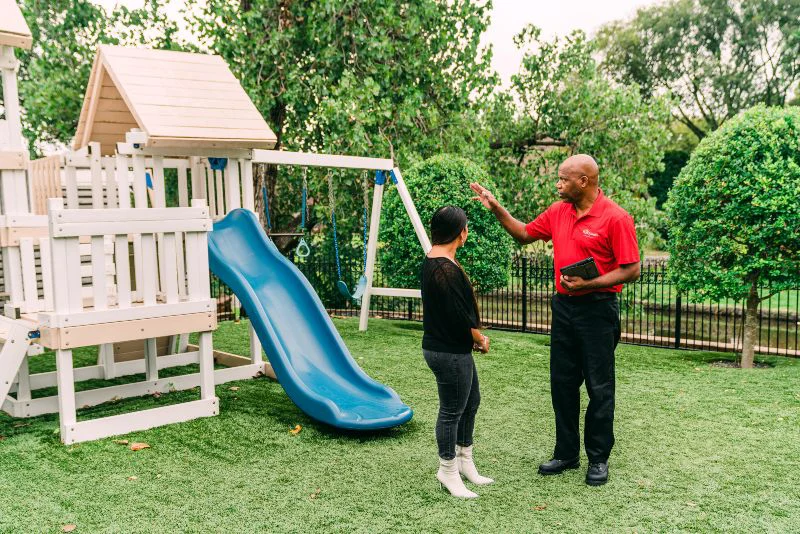 A handyman in Charleston, SC speaking with a homeowner outside of their home.