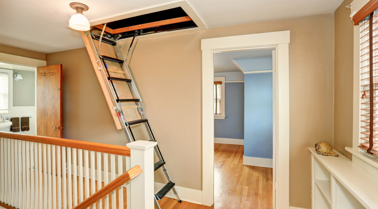 A retractable attic ladder fully extended from a ceiling hatch