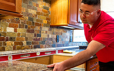 A Mr. Handyman Technician installing new countertops.