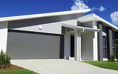 Grey house with two car garage.